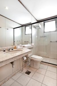 a bathroom with a toilet, sink, and shower at Promenade Pancetti Belo Horizonte in Belo Horizonte
