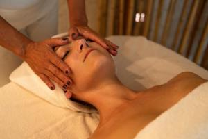 a woman getting her face massage in a spa at Acaya Golf Resort & Spa in Acaya