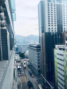 an aerial view of a city with traffic and buildings at Kyoto Guest House (15/F) in Hong Kong