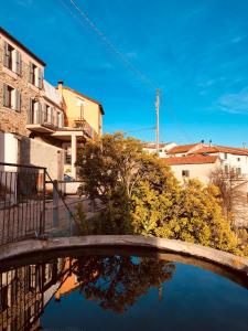 a bridge over a body of water with buildings at Bed and breakfast Ca du 5 in Tovo San Giacomo