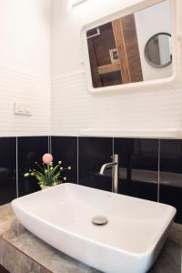 a white sink in a bathroom with a mirror at Bang Po Garden in Ban Bang Po