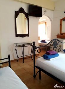 A bed or beds in a room at EVANS Skiathos