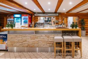 a bar in a restaurant with stools at Atpūtas komplekss Lācītes in Ranka