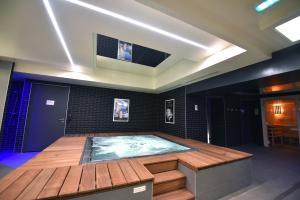 a hot tub in the middle of a room at Kyriad Hotel Dijon Gare in Dijon