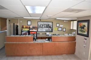 a restaurant with a counter in a store at Super 8 by Wyndham Ocala I-75 in Ocala