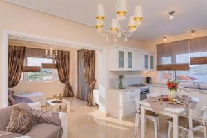 a kitchen and living room with a chandelier at Grand View Villas in Samos