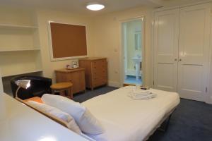 a hotel room with a bed and a desk at Wadham College in Oxford
