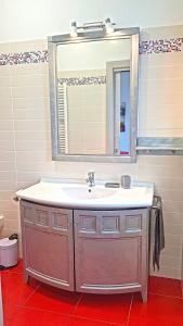 a bathroom with a sink and a mirror at Villetta Sogno sul Lago by Gardadomusmea in Tremosine Sul Garda