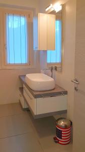 a bathroom with a sink and a mirror at Villetta Sogno sul Lago by Gardadomusmea in Tremosine Sul Garda +23 photos
