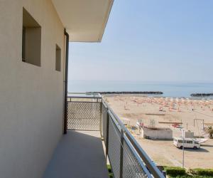 a balcony with a view of the beach at Hotel Tritone Rimini in Rimini