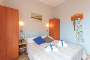 a bedroom with a bed with two towels on it at Hotel Tritone Rimini in Rimini