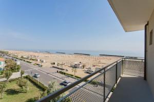 a balcony with a view of the beach at Hotel Tritone Rimini in Rimini
