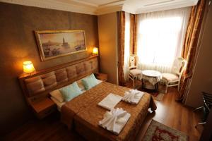 a bedroom with a bed with two towels on it at Hotel Tashkonak Istanbul in Istanbul