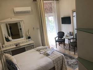 a bedroom with a bed and a mirror and a table at Lord's Residence Boutique Hotel in Kyrenia