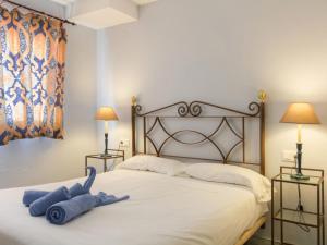 a bedroom with a bed with blue towels on it at Apartment Las Terrazas by Interhome in Marbella