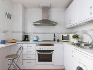 a white kitchen with a sink and a stove at Apartment Las Terrazas by Interhome in Marbella +28 photos