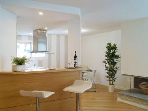 a kitchen with two white chairs and a fireplace at Apartment Fontanilla by Interhome in Marbella