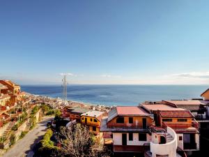 a view of a city with the ocean in the background at Apartment Il Poggio by Interhome in Letojanni