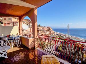 a balcony of a building with a view of the ocean at Apartment Il Poggio by Interhome in Letojanni