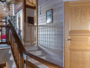a wooden staircase in a house with a wooden door at Holiday Home Utsu 1 by Interhome in Levi
