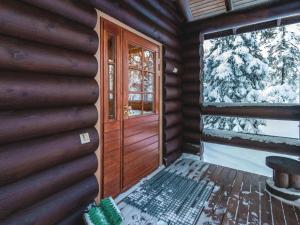 a front door of a log cabin with a window at Holiday Home Utsu 1 by Interhome in Levi