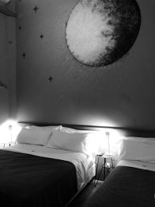 a bedroom with two beds with a moon mural on the wall at Franca City Hostel in Buenos Aires