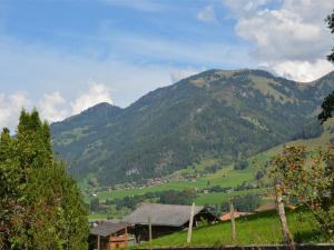a view of a mountain with a village in the foreground at Apartment Spillgerten-Blick by Interhome in Zweisimmen