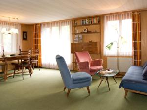 a living room with a couch and chairs and a table at Apartment Pony 5-Bettwohnung by Interhome in Lenk