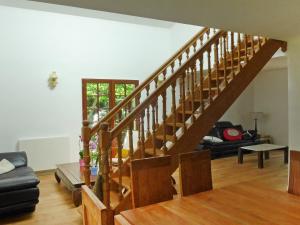 a wooden staircase in a living room with a table at Holiday Home Lac Marion by Interhome in Biarritz