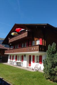a large building with a balcony on top of it at Apartment Bärnermutz # 1 by Interhome in Lenk