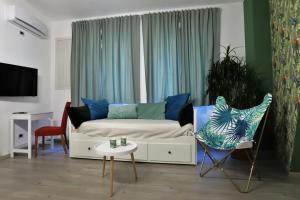 a living room with a bed and two chairs at Napoli Vesuvio Apartments by Dimorra in Naples