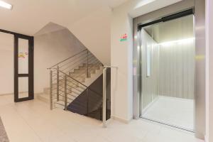 a hallway with a staircase and a glass door at Apartament Przy Latarni in Kołobrzeg