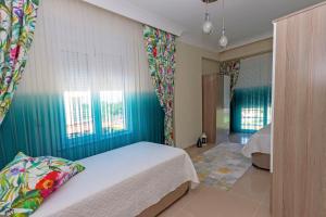 a bedroom with a bed and a blue wall at Paradise Town Villa Beltania in Belek +48 photos