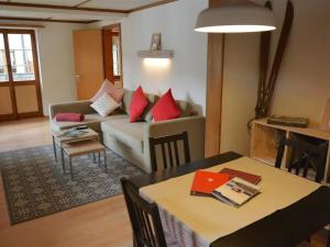 een woonkamer met een bank en een tafel bij Apartment Oehrli by Interhome in Gstaad