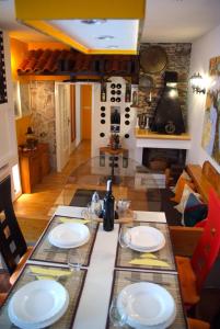a dining room with a table with plates on it at Guesthouse 7even in Mostar