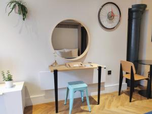 a table with a blue stool and a mirror at I Should Cocoa (York) - Seebohm in York