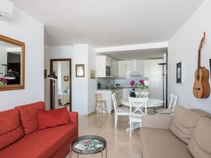 a living room with a red couch and a table at Apartment Carmen Vistamar by Interhome in Estepona