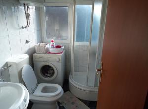 a bathroom with a toilet and a washing machine at Studio apt. Downtown in Split