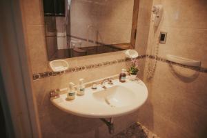 a bathroom with a sink and a mirror at San Rafael Group Hotel in San Rafael