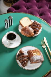 a table with two plates of pastries and a cup of coffee at The Prospect Hollywood in Los Angeles