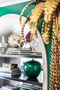 a mirror on a shelf with a green vase at The Prospect Hollywood in Los Angeles