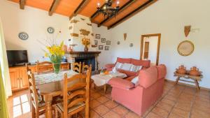 Casa Rural El Moral في مالقة: غرفة معيشة مع أريكة وطاولة
