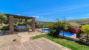 an external view of a villa with a swimming pool at Casa Rural El Moral in Málaga