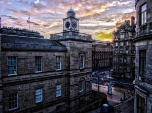 an old building with a clock tower on top of it at Haystack Hostel in Edinburgh