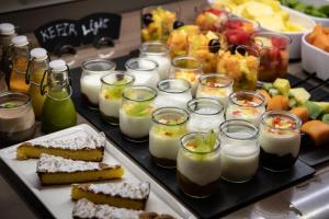 a table with a tray of food with desserts and candles at Catalonia Donosti in Donostia-San Sebastián