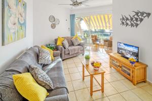 a living room with a couch and a tv at 207 Kings Palace Seaview in Paphos City