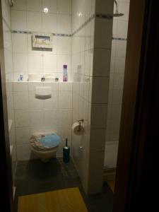 a bathroom with a toilet and a sink at Pension Heideweg in Weeze