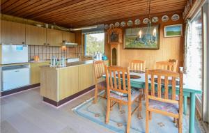 a kitchen with a table and chairs and a counter at 2 Bedroom Beautiful Home In Fur in Fur
