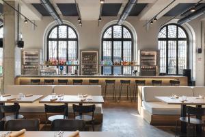 a restaurant with tables and chairs and a bar at Combo Torino in Turin