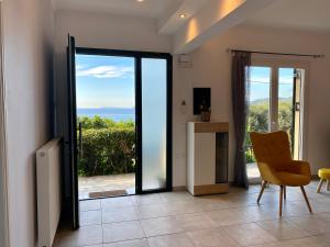 Habitación con puerta corredera de cristal y vistas al océano. en Coralli Pentati 2 "Dimitris Apartments" en Pentati